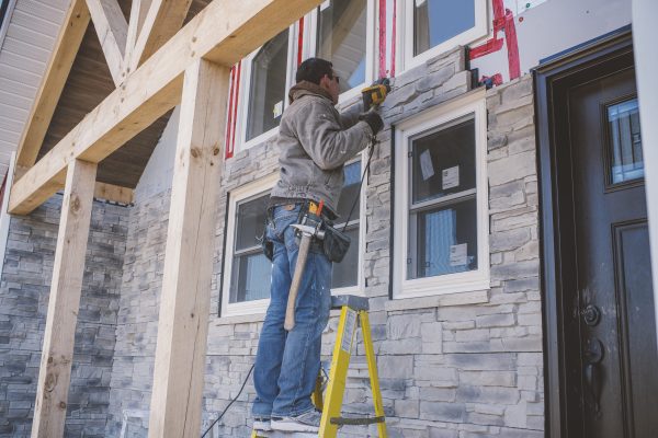 Builder tiling facade of house